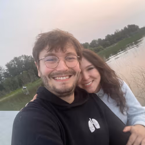 Lindsay and Tristan sitting on the dock at the lake