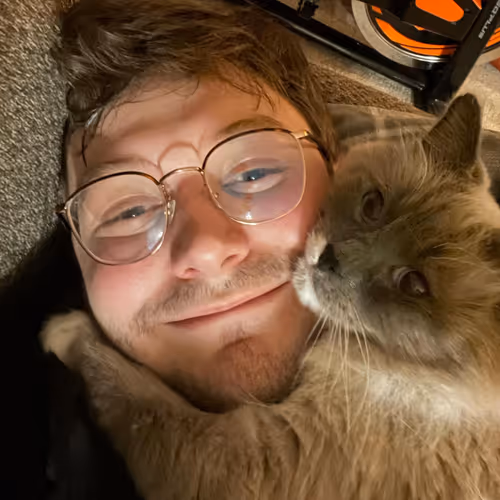 Tristan and Perry the cat cuddling